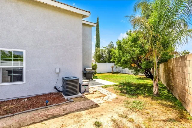a backyard of a house with yard and outdoor seating