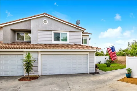 a front view of a house with plants