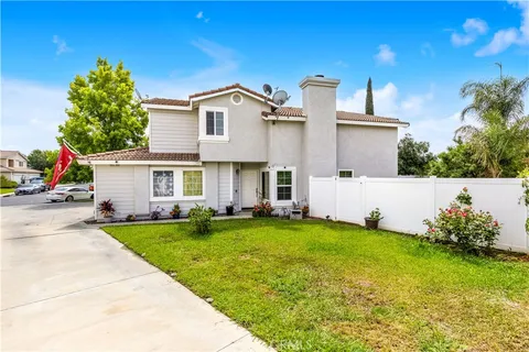 a view of a house with a yard and sitting area