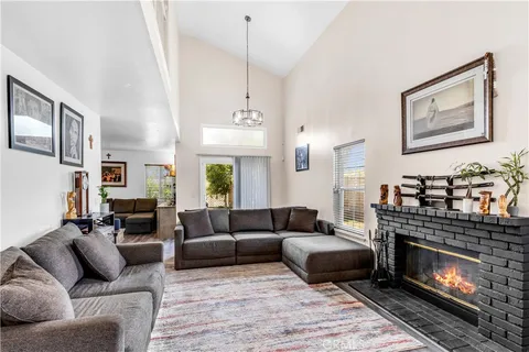 a living room with furniture a window and a fireplace