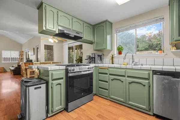 a kitchen with cabinets a sink and appliances