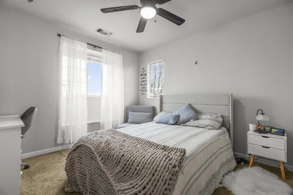 a bedroom with a bed and a chandelier