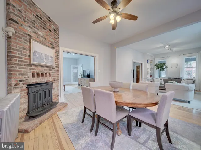a view of a dining room with furniture and a potted plant