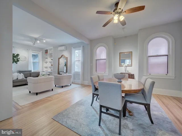 a bedroom with a large bed a chandelier and windows