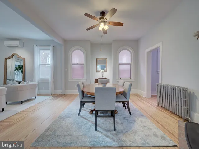 a spacious bedroom with a bed and a chandelier