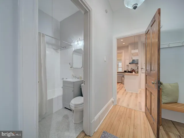 a view of an empty room with wooden floor