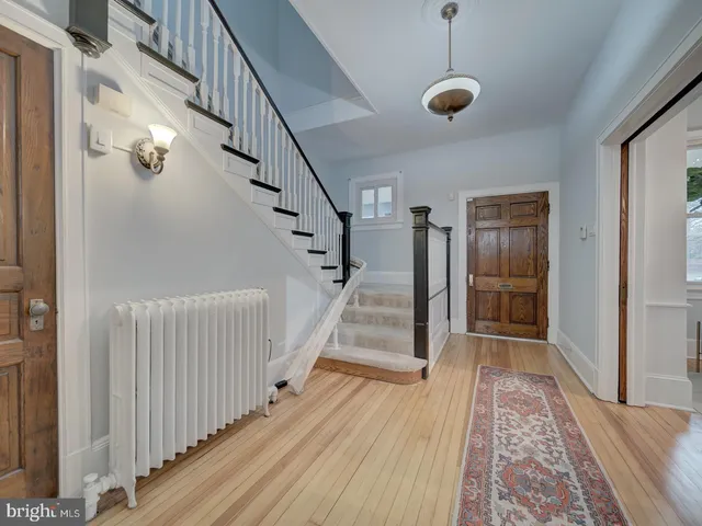 a view of a dining room with furniture a chandelier and wooden floor