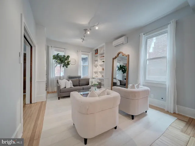 a view of a dining room with furniture and a chandelier fan