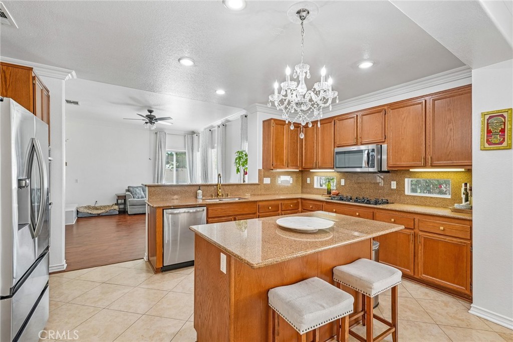 46101 Sharon Street Temecula, CA 92592 - Photo 14 of 34 a kitchen with a center island appliances and cabinets