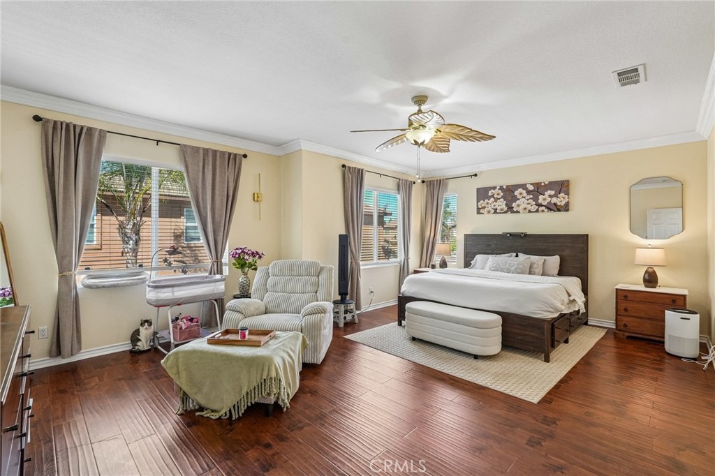 46101 Sharon Street Temecula, CA 92592 - Photo 20 of 34 a spacious bedroom with a large bed a couch and large window