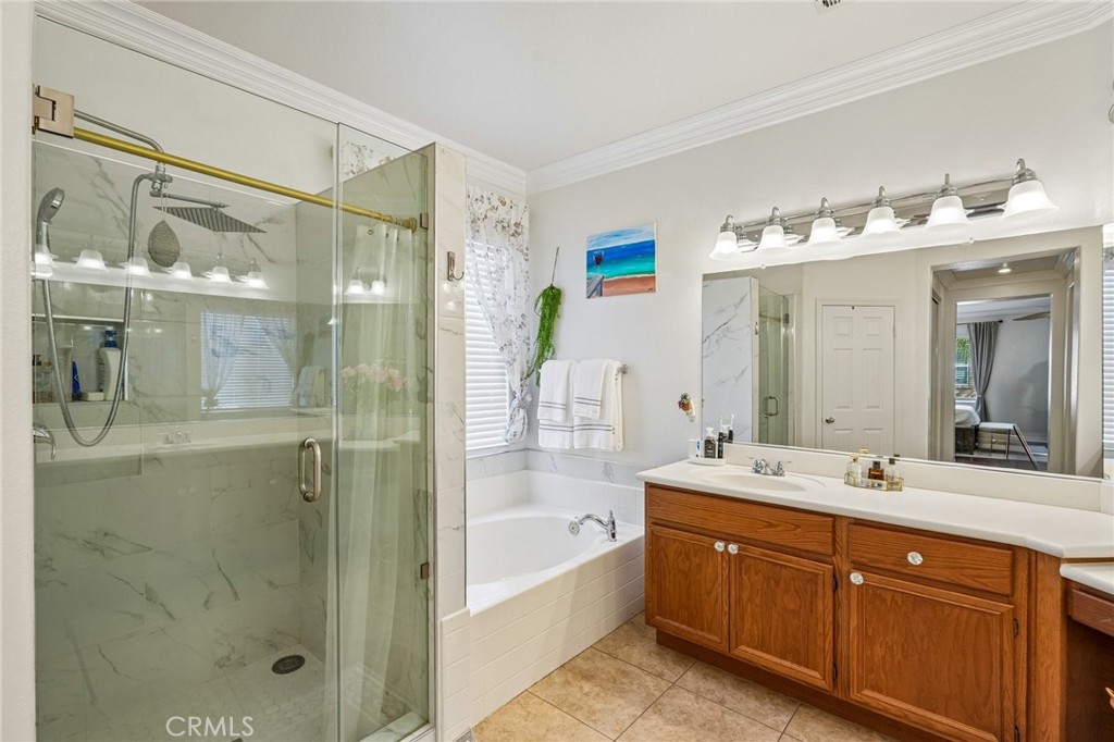 46101 Sharon Street Temecula, CA 92592 - Photo 23 of 34 a spacious bathroom with a shower sink and mirror with shower