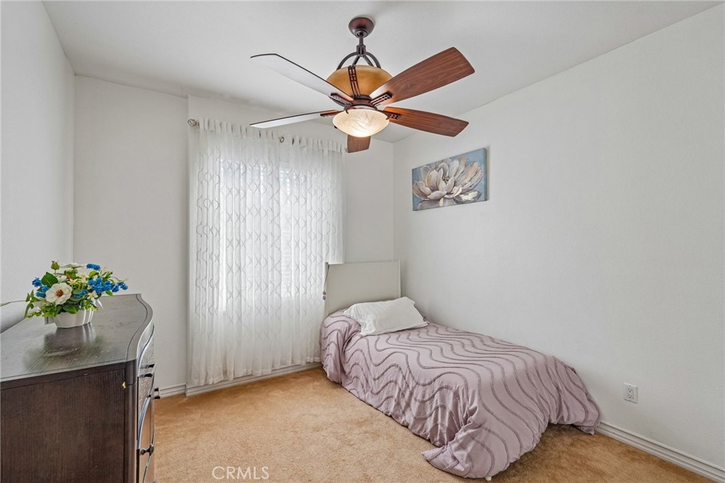 46101 Sharon Street Temecula, CA 92592 - Photo 25 of 34 a bedroom with a bed and a chandelier