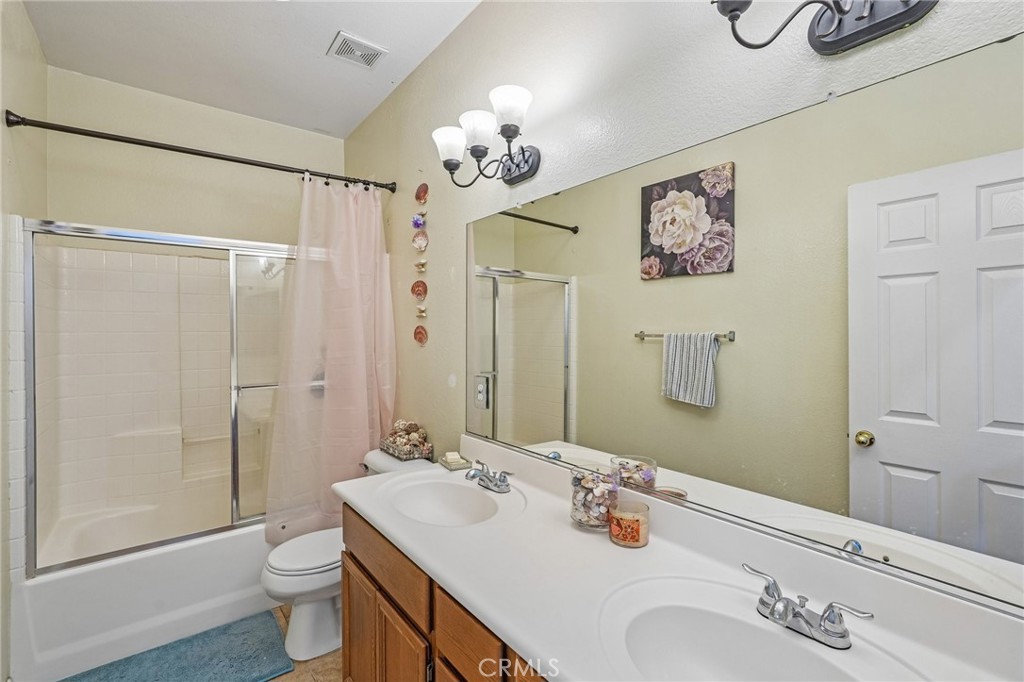 46101 Sharon Street Temecula, CA 92592 - Photo 27 of 34 a bathroom with a sink a toilet and shower