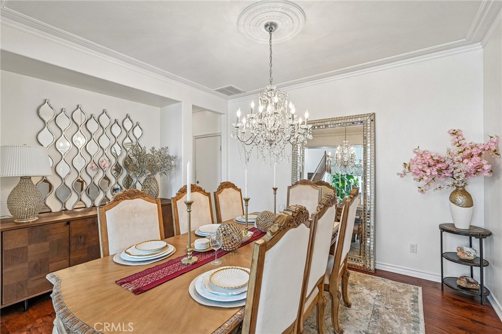 46101 Sharon Street Temecula, CA 92592 - Photo 10 of 34 a dining room with furniture a chandelier and wooden floor