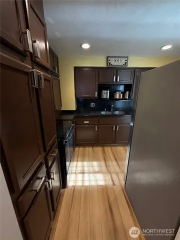 a view of kitchen with refrigerator and window