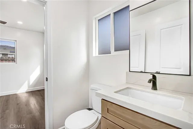 a view of a big room with wooden floor closet and windows