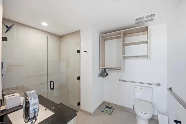 a bedroom with furniture and a large window