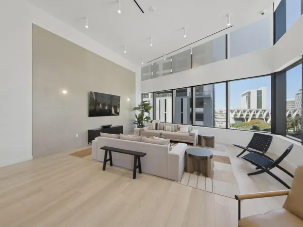 a view of a dining room with furniture and a chandelier