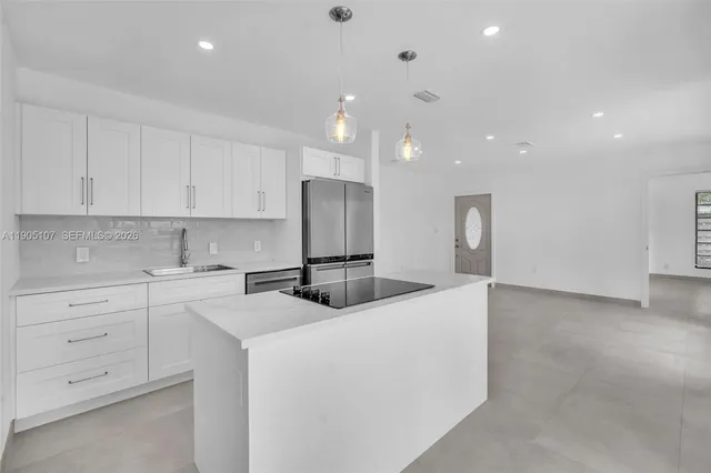a kitchen with cabinets and stainless steel appliances