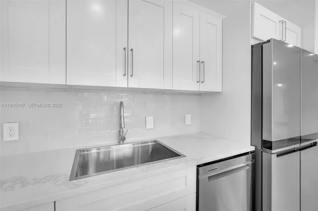 a kitchen with a refrigerator and cabinets