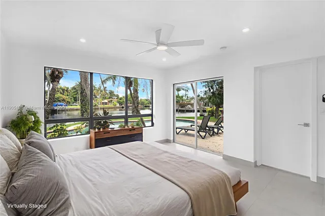 a bedroom with a large bed and a large window