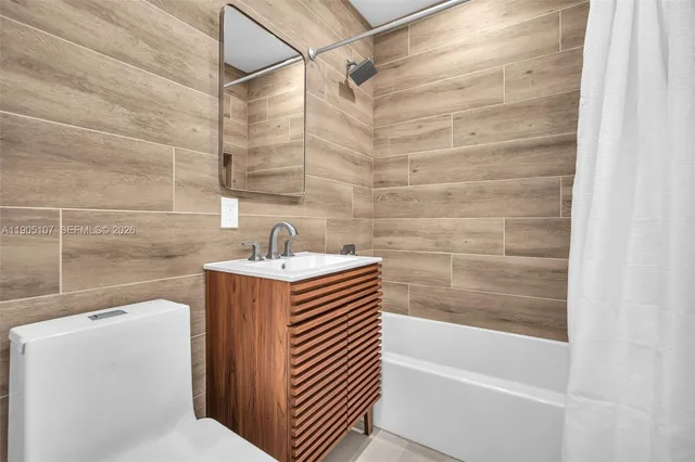 a bathroom with a sink a mirror and a shower