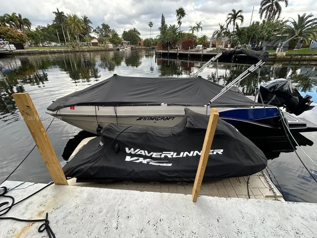 a view of a balcony with chairs and potted plants