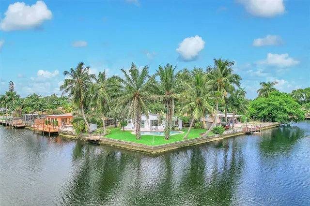 a view of a lake with boats and trees all around