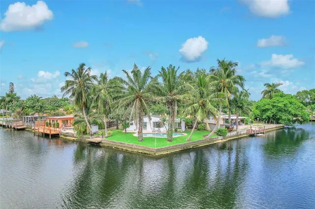 a view of a lake with boats and trees all around
