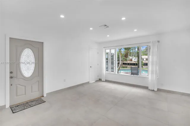 an empty room with a fireplace and a window