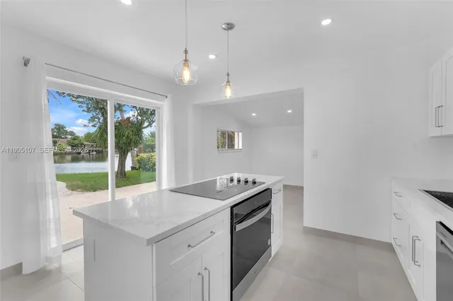 a kitchen that has a sink and a stove