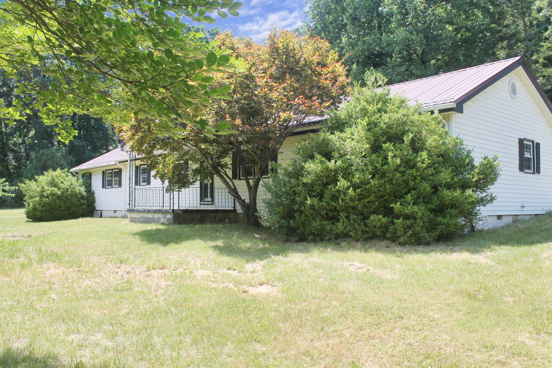 1062 Quartz Road Blue Ridge, VA 24064 - Photo 3 of 26 a view of a house with a yard garage and a tree