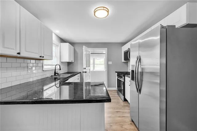 a kitchen with refrigerator and window