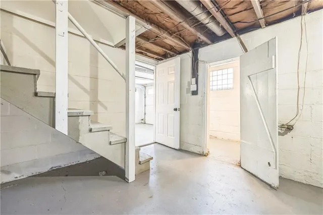 a view of a room with wooden floor and windows