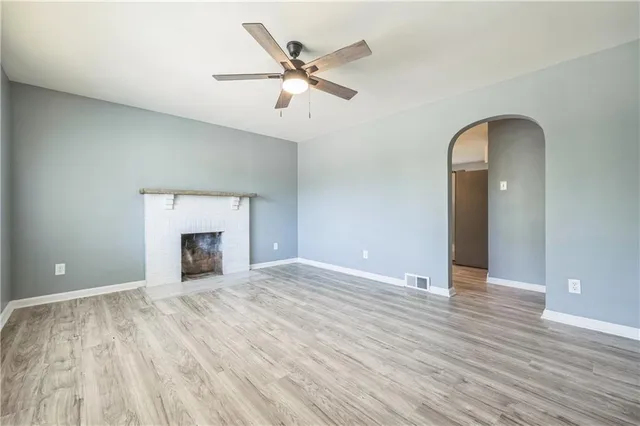 wooden floor in an empty room with a fireplace