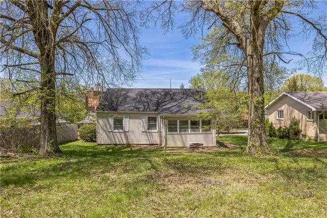 a house that has a tree in front of it