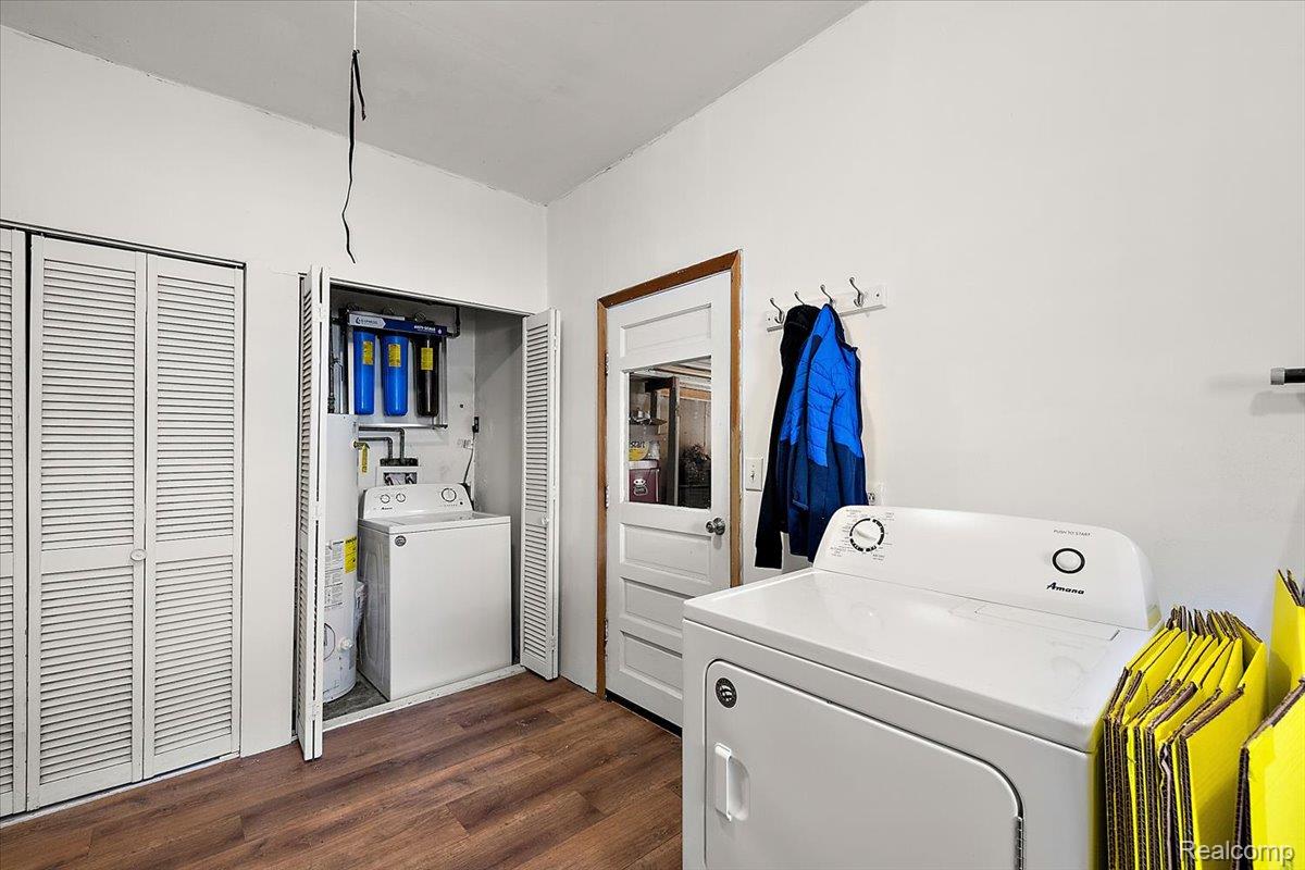 4705 Ketchum Road St. Clair, MI 48079 - Photo 32 of 58 Laundry area with dark wood-style flooring, separate washer and dryer, and water heater