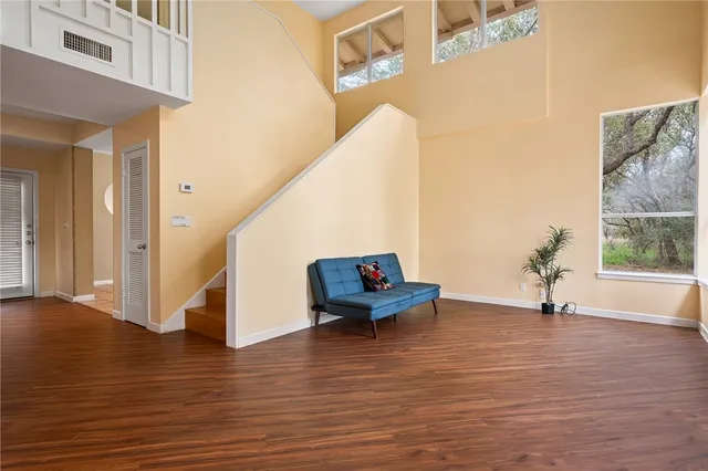 a view of a room with wooden floor and bench