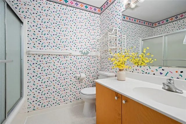 a bathroom with a sink toilet and shower