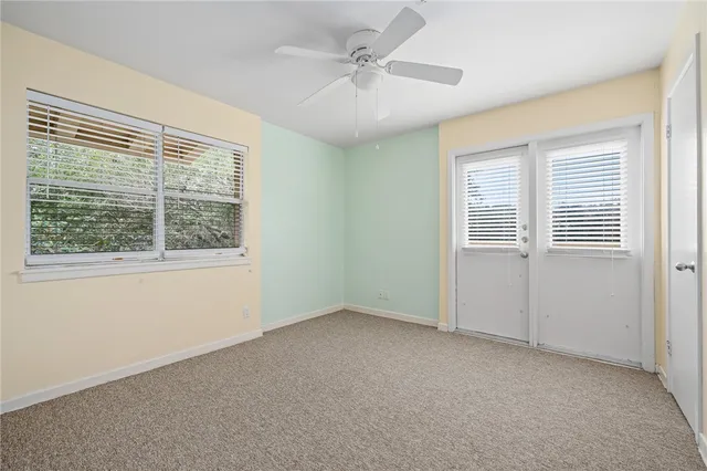 an empty room with windows and closet