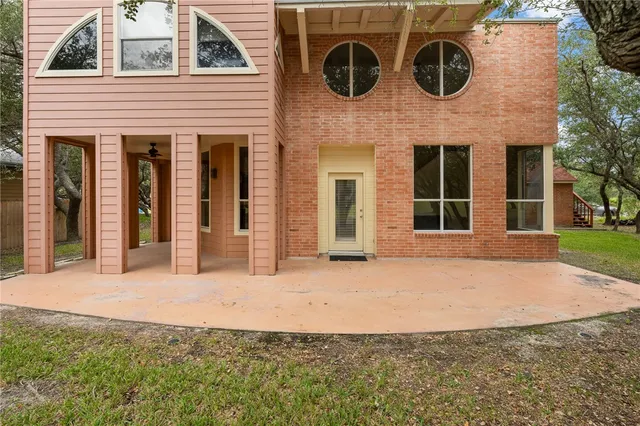 front view of a brick house with large windows