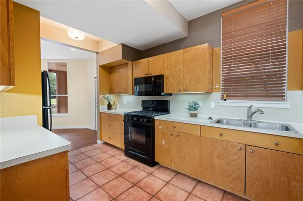 a kitchen with stainless steel appliances granite countertop a sink and a stove
