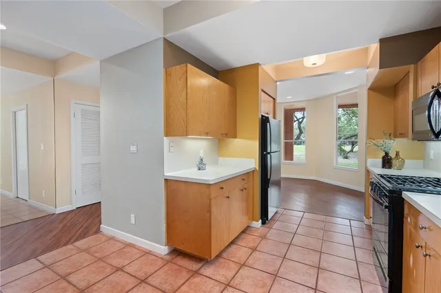 a kitchen with a stove a sink and a refrigerator