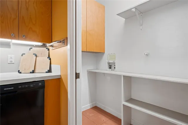 a view of storage and utility room with two washing machine