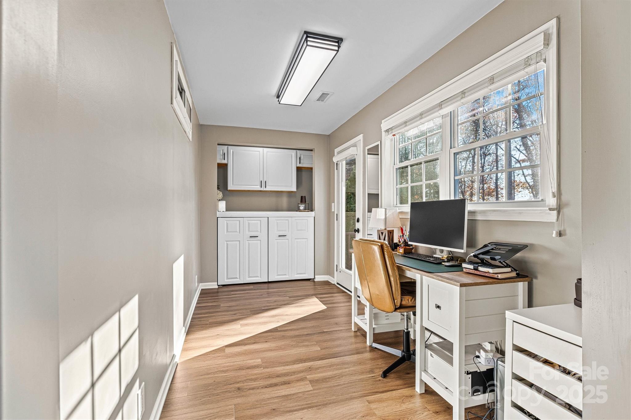 7176 Hunters Bluff Drive Denver, NC 28037 - Photo 12 of 36 a workspace with furniture a flat screen tv and a window