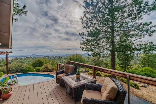 a living room with furniture a fireplace and wooden floor