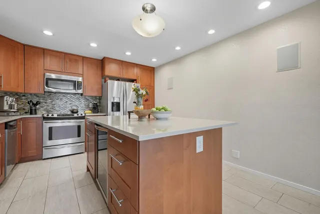 a view of empty room with wooden floor and fireplace