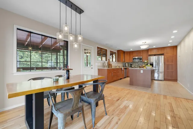 a view of a livingroom with workspace and a window
