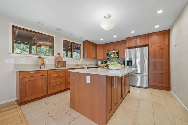 a spacious bathroom with a mirror a sink and a shower