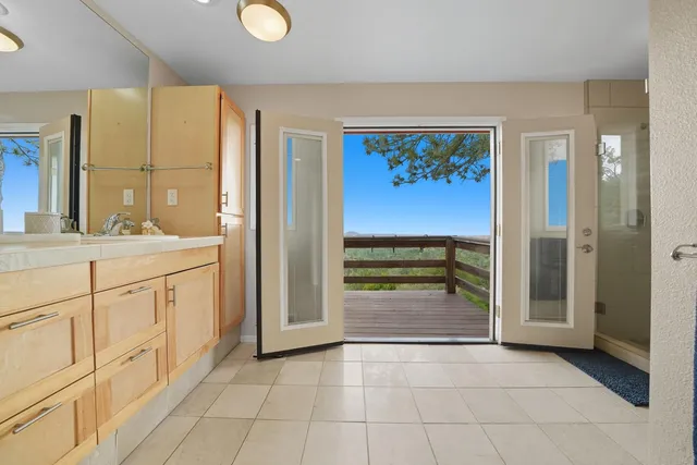 a view of a yard with plants and wooden fence